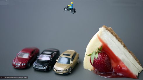 Christopher Boffoli's photograph of a toy motorcycle rider, jumping over three toy cars and a slice of cheesecake