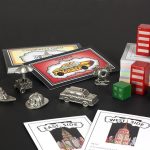 Close up of all the Fazzino Monopoly pieces and cards