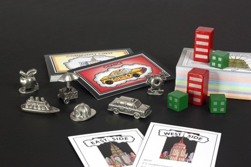 Close up of all the Fazzino Monopoly pieces and cards
