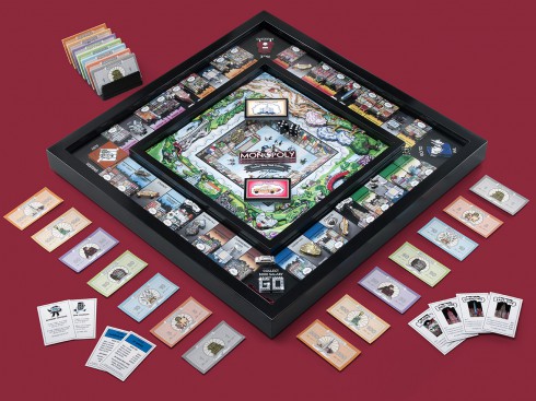 Full Game of the Fazzino version of Monopoly, laid out on a red carpet, with all the pieces placed for viewing