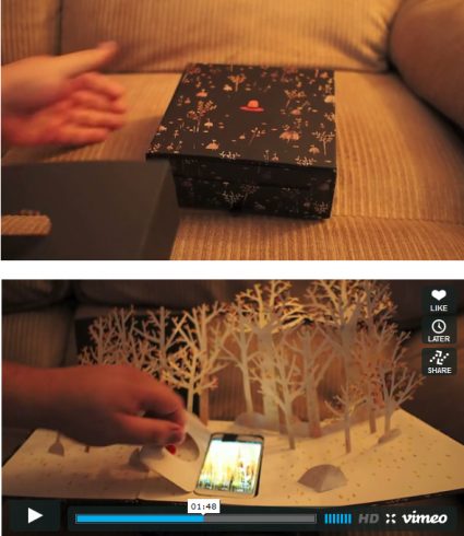 Image of Motorola's pop up book sitting on a coach, following another image with the book opened and a person playing with their phone in the pages