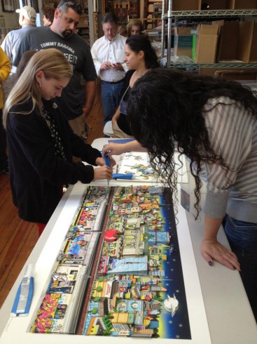 Two young women working on a 3D painting at the ArtsFests Fazzino workshop