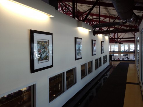 View looking down a Chelsea Pieres hallway where four of Fazzino sports artwork is hanging