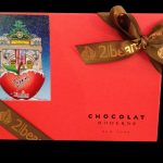 Image of the top of the 2|Beans, Fazzino style box of chocolate, with a red cover and an image of Fazzino pop art