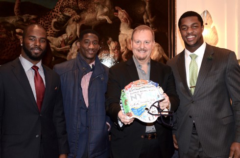 Fazzino posing for a picture with Michael Cox, Antrel Rolle, Quinton Coples at the Super Bowl artwork reveal at the Holiday House in NYC