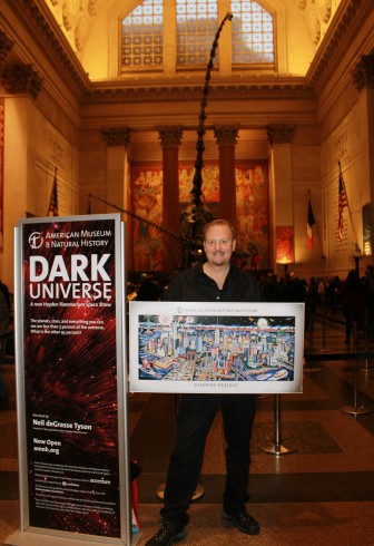 Charles Fazzino standing in the Museum of Natural History proudly holding one of his posters