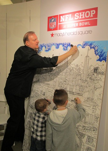 Working with Young Artists at Family Day to color in a giant version of the Super Bowl Artwork