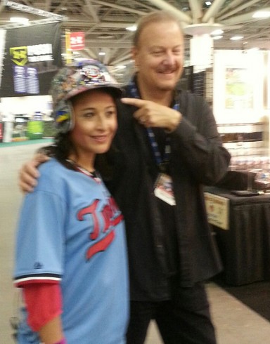 Melissa Colorado wearing a Fazzino hand painted MLB baseball helmet as they pose for a picture.