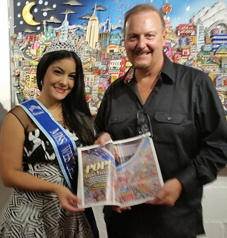 Charles Fazzino and Miss Westchester Briana Coralys holding up the Arts Westchester Magazine 