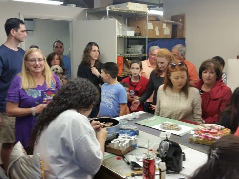 A group of fans inside the Fazzino art studios getting a behind the scenes glimpse of work in progress