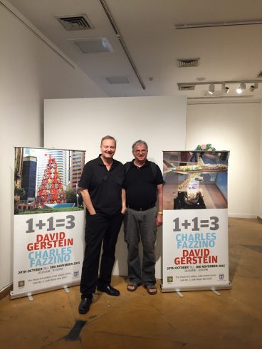 Charles Fazzino and David Gerstein pose in front of posters for their joint exhibition in New Delhi