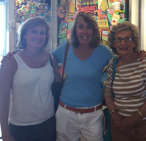 Three teachers from New Rochelle pose for a photo in front of a Fazzino Broadway piece