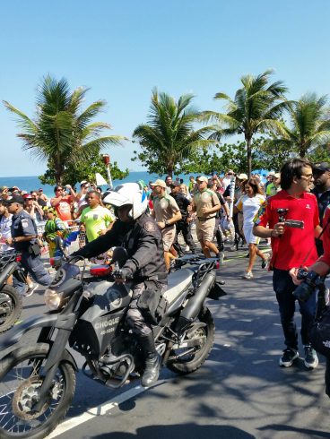 Police man riding a bicycle directing the 2016 Olympic Game Torch Relay in Rio de Janeiro