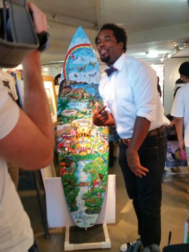 NBC's, Dhani Jones, stopped The USA house to admire Charles Fazzino's 2016 Olympic Games surfboard in Rio.