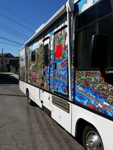 Side view of the custom wrapped Westchester Medical Center Health Center bus