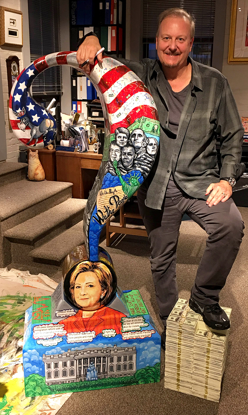 Charles Fazzino standing next to his Hilary Clinton question mark sculpture dedicated to the 2016 presidential debate 