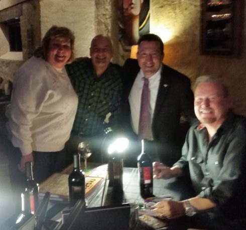 Charles Fazzino taking a photo with fans after signing a bottle of the 2014 Napa Valley Blend