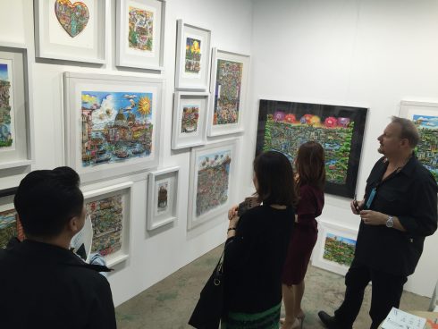 Charles Fazzino looking at his 3d Pop Art work with fans in Korea