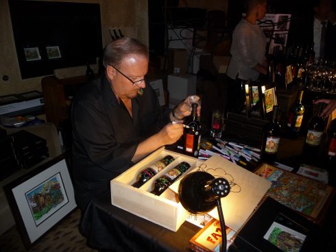 Charles Fazzino signing bottles at the Winery at St. George Napa Valley Blend Release Party