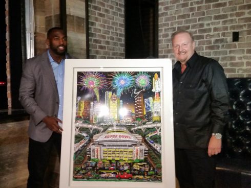 Houston Texan Whitney Mercilus with Charles Fazzino standing with the Super Bowl LI poster