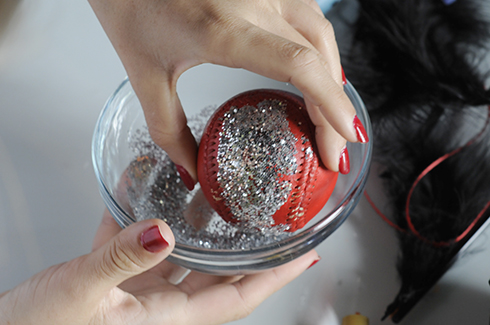 A bowl of glitter to dunk a baseball with glue to coat it 