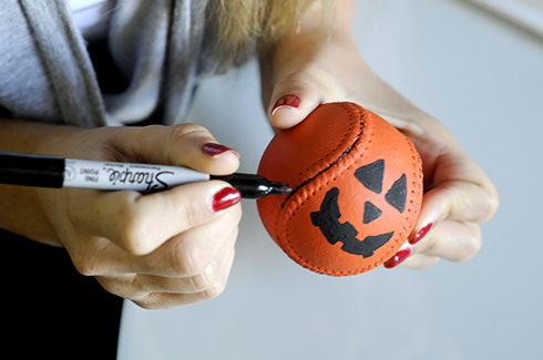 Using an art marker to highlight the stitching on a baseball