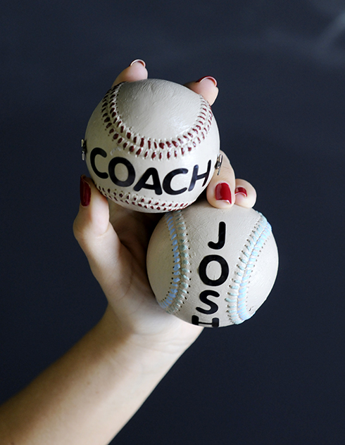 Holding two baseball art pieces for players and coaches