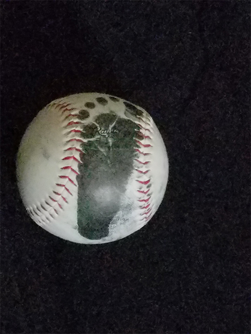 A baseball with a footprint of a newborn baby