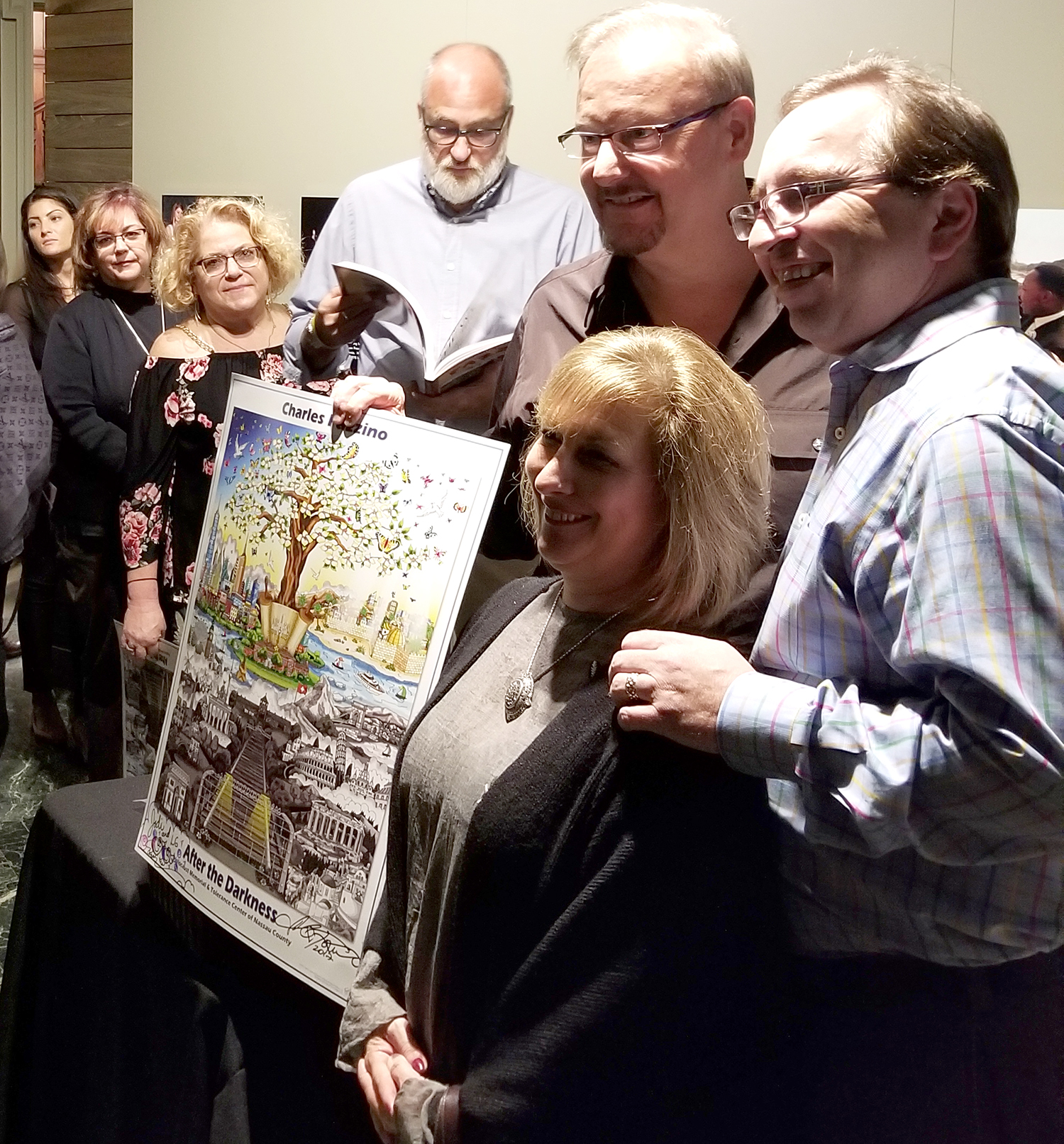 Charles Fazzino and friends gathered to take a photo with a "After the Darkness" signed pop art print