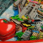 A close up of a Fazzino artwork showing an apple in 3D