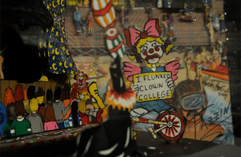 A close up of a Fazzino piece showing a clown holding a sign that says I flunked clown college