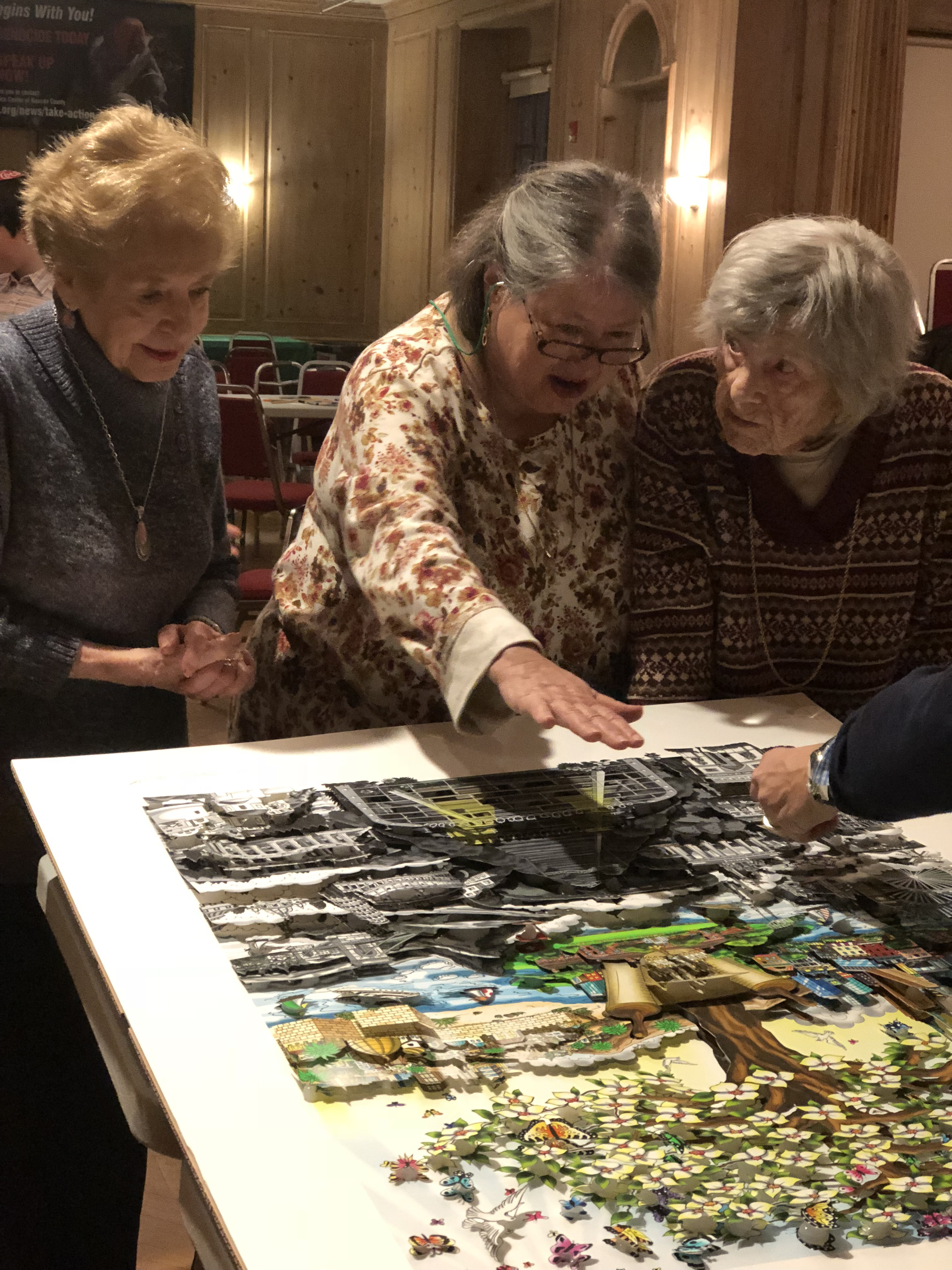 Anita Weisbord, Ethel and Felice Katz work on recreating "After the Darkness" 3d pop art piece by Charles Fazzino