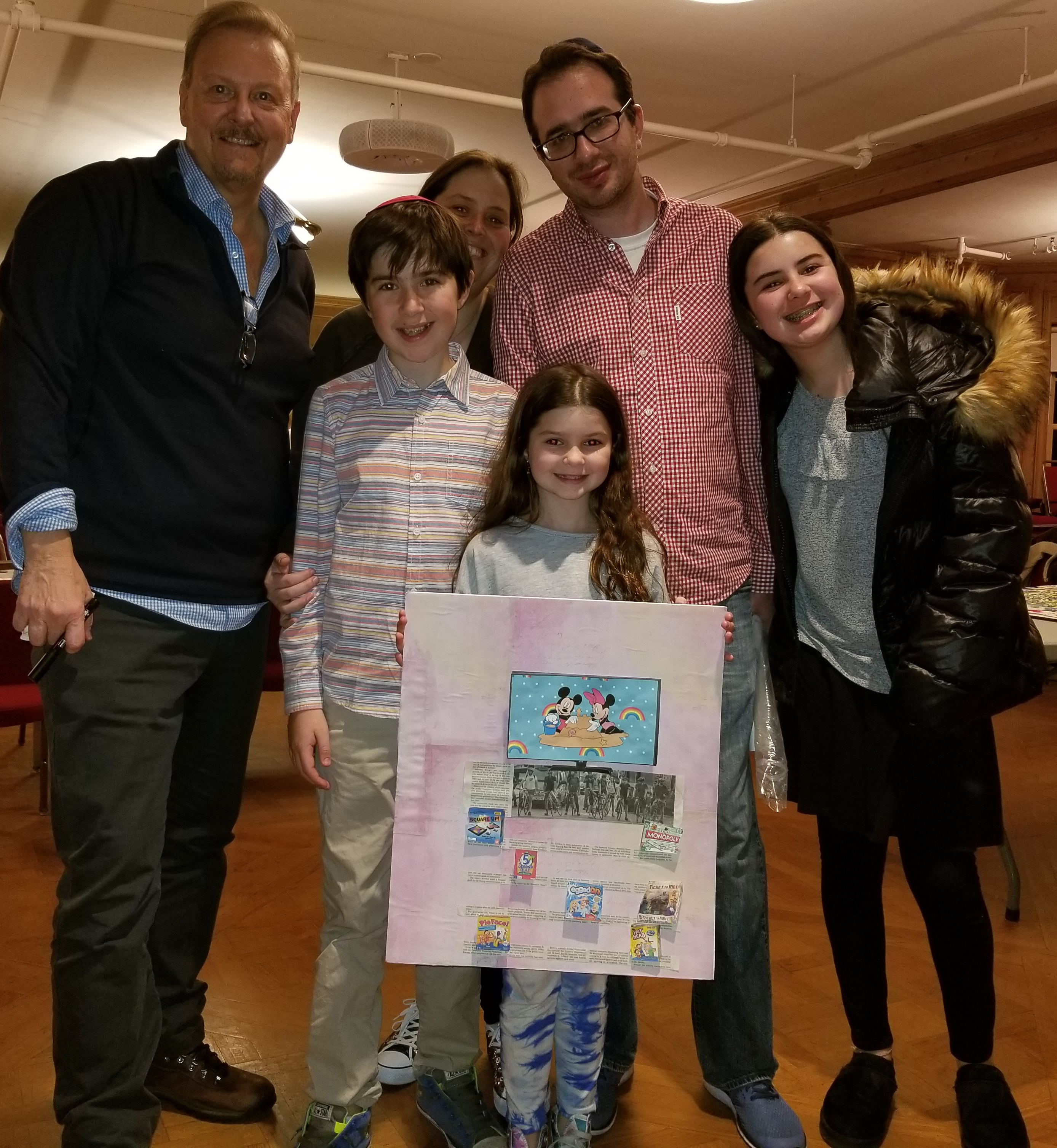 Charles Fazzino posing with a couple with three kids 