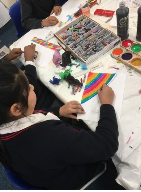 Little girl using a variety of colors in her New Years Celebration art piece