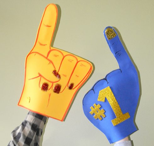 Orange and blue foam fingers cheering for their favorite team