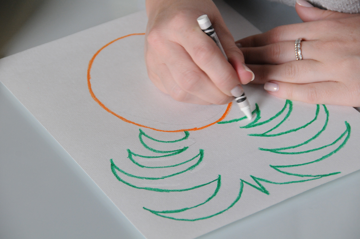 Adding white crayon as a resist to prep a pineapple watercolor painting