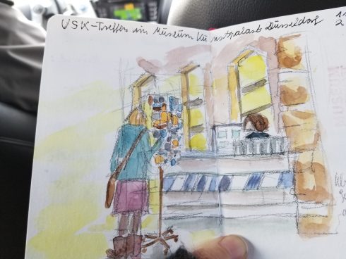 A German taxi drivers colored sketch of a person looking through a rack at a gift shop - Urban Sketchers society