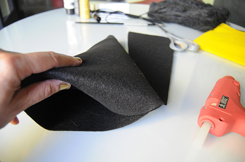 Cutting the excess felt and tucking in the front flap