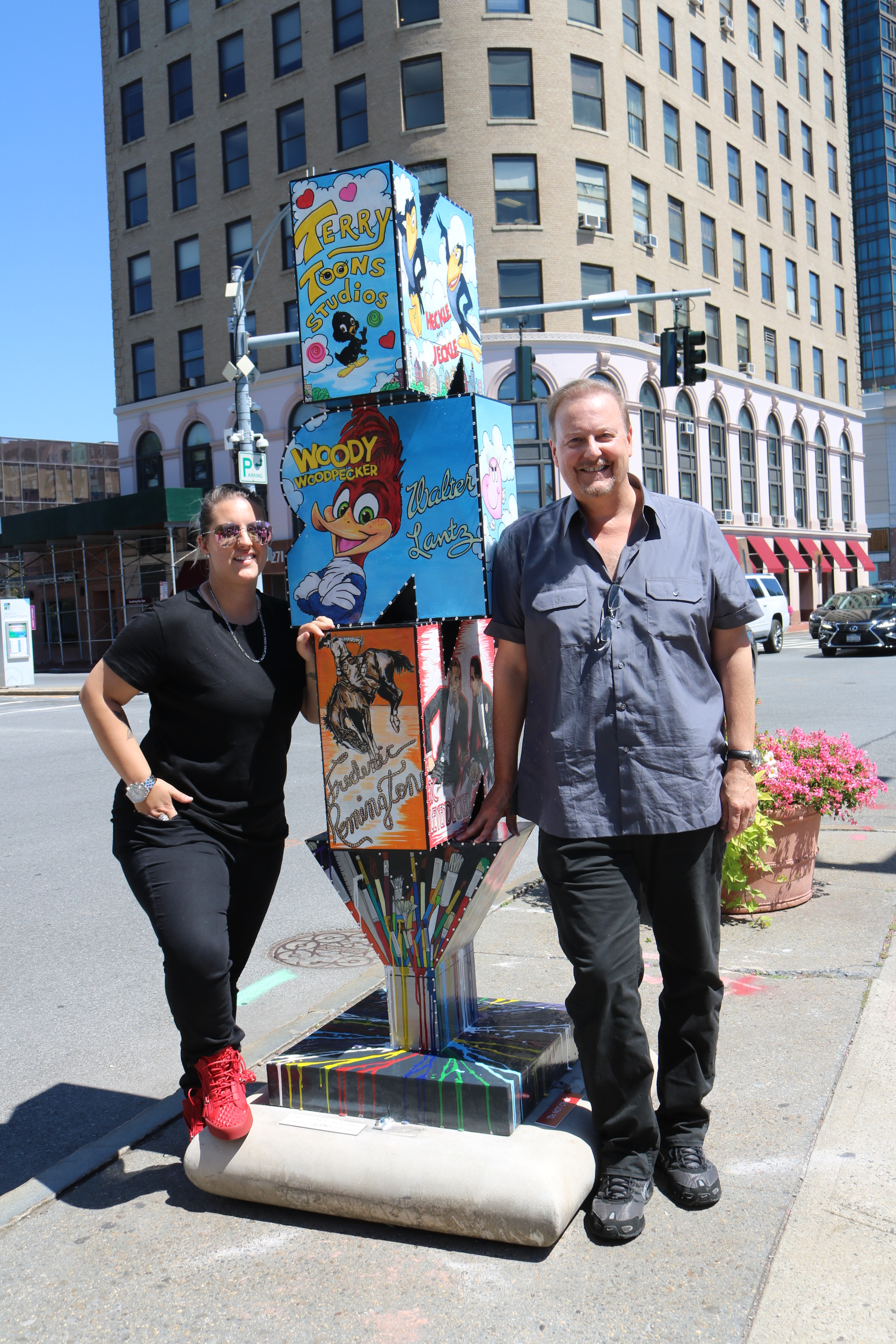 Heather and Charles Fazzino standing next to Charles' pop art New Rochelle sculpture