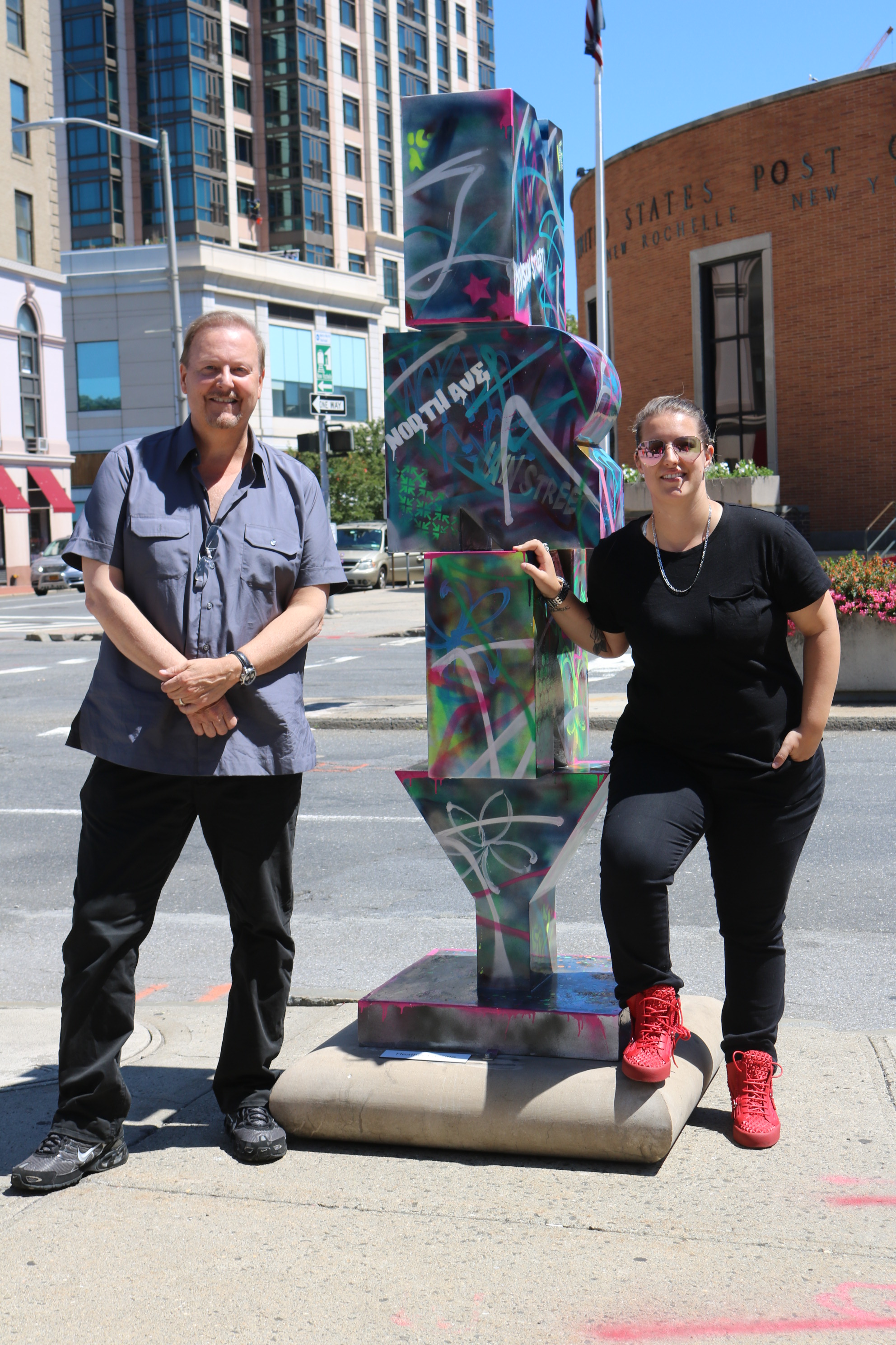 Heather and Charles Fazzino standing next to Heather's graffiti inspired New Rochelle sculpture