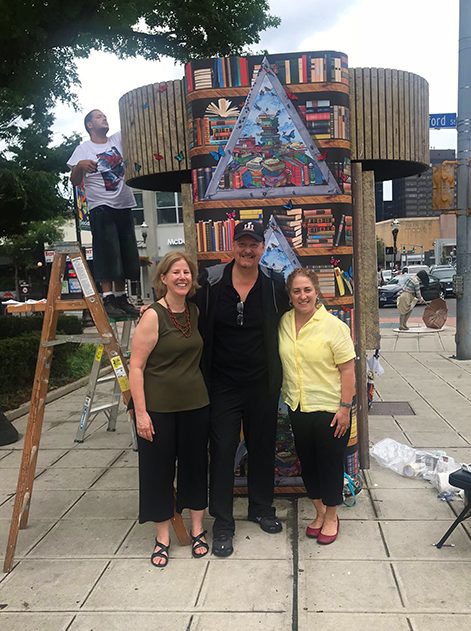 Fazzino and friends posing and smiling in front of Stamford CT library kiosk 