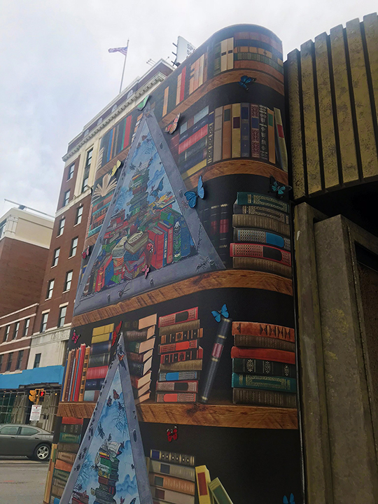 3D pop art piece of a bookshelf with triangle windows and 3d butterflies done by Charles Fazzino