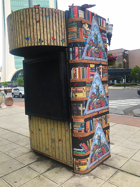 Kiosk in front of Ferguson Library in Stamford Connecticut wrapped in artwork from Charles Fazzino 