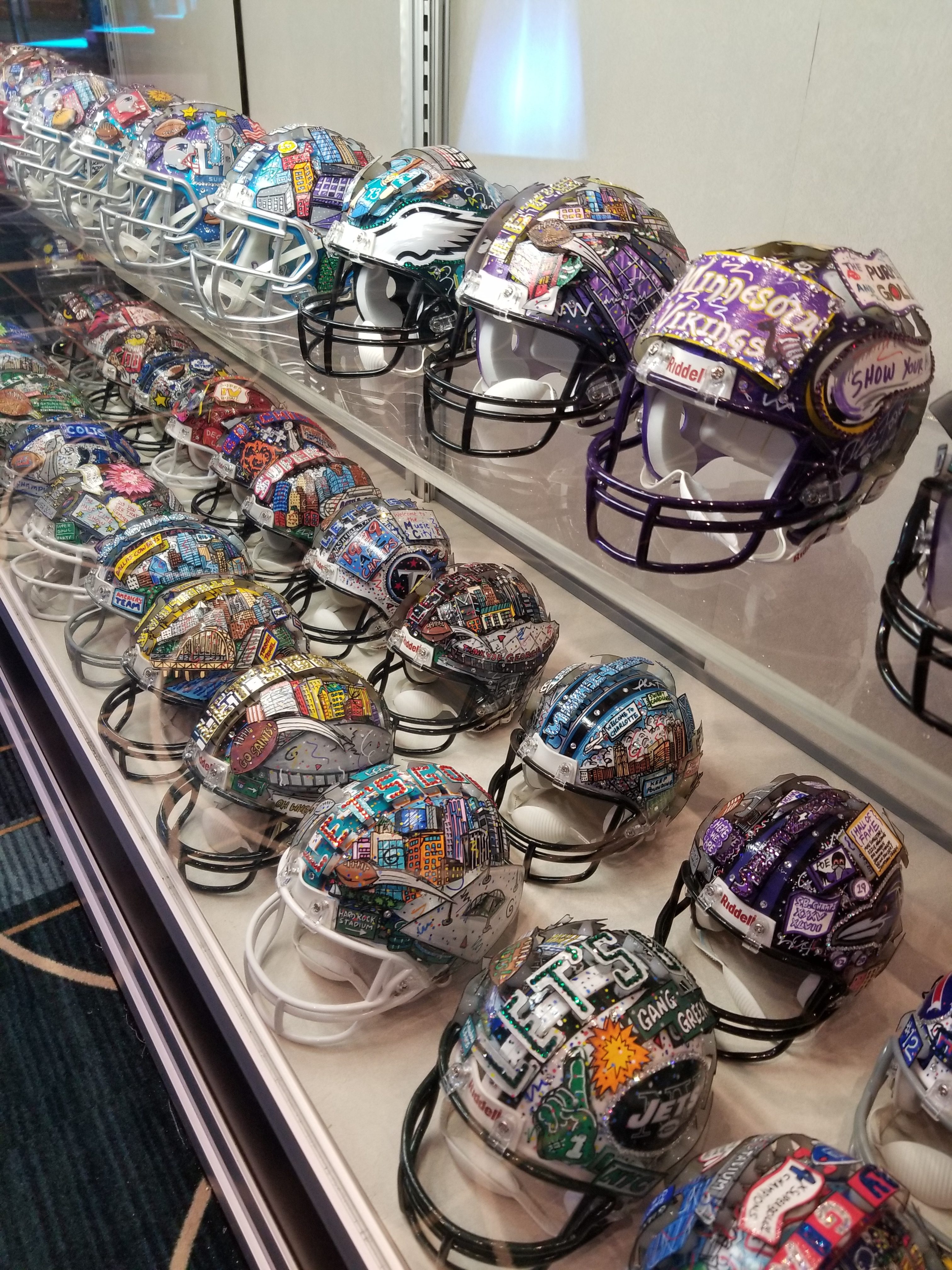 The hand painted Fazzino mini football helmet art collection on display at the NFL Experience