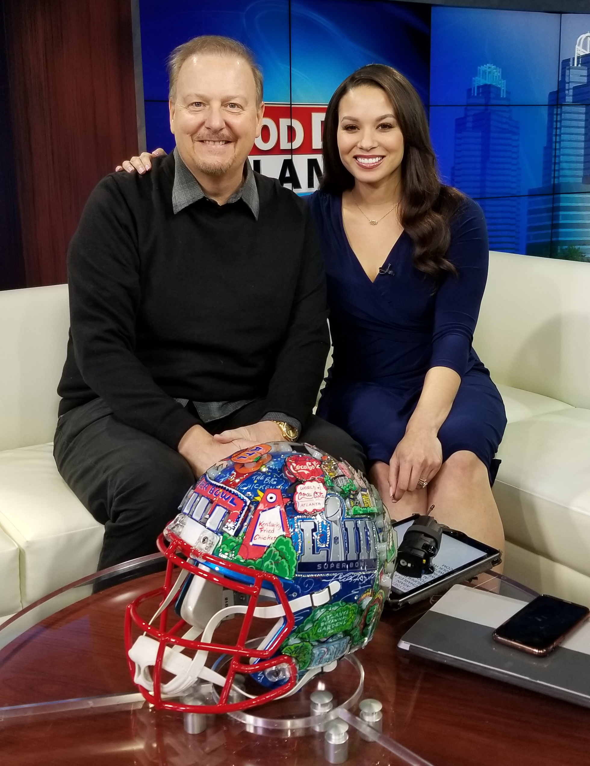 Charles Fazzino on Fox 5 Good Day Atlanta posing in front of his helmet artwork for Super Bowl LIII