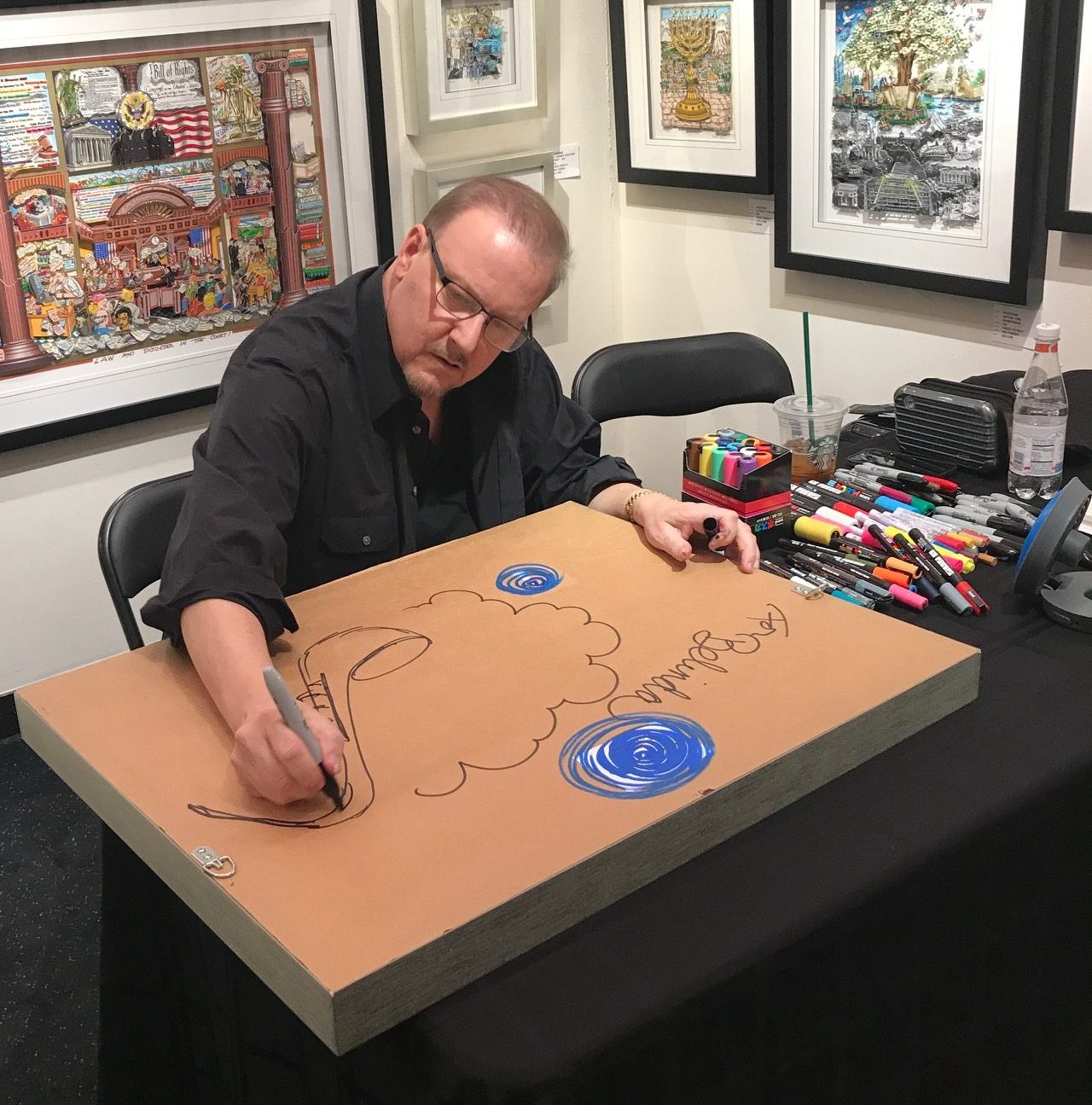 Fazzino sits down at the Wentworth Gallery to start a live drawing for fans to watch