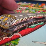 glueing a train car to Charles Fazzino