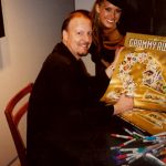 Charles Fazzino signs posters with supermodel Petra Nemcova at The GRAMMY Awards