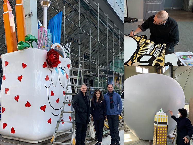 Collage of images - upper right is Fazzino working on the installation, lower right is another person working on the installation. Left image is Fazzino smiling with two people in front of the installation.