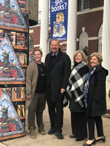 Image of Heather Fazzino, Charles Fazzino, Alice Knapp, President of Ferguson Library and Sandy Goldstein standing next to the commissioned kiosk.